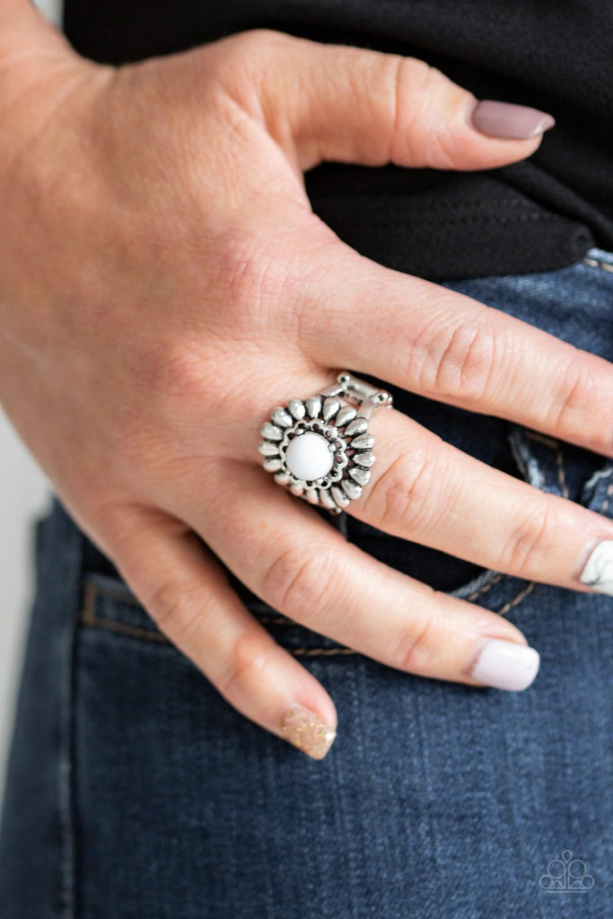 A shiny white bead is nestled atop a stacked floral frame, creating a colorful flower atop the finger. Features a stretchy band for a flexible fit.  Sold as one individual ring.