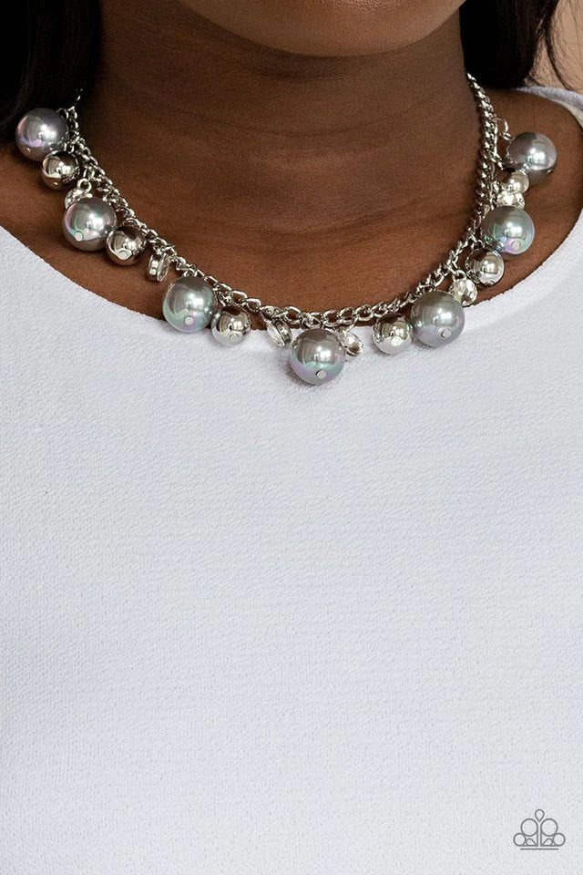 An oversized collection of shiny silver beads, white rhinestone accents, and silvery iridescent pearls dangle from a classic silver chain, creating a stellar fringe below the collar. Features an adjustable clasp closure.  Sold as one individual necklace. Includes one pair of matching earrings.