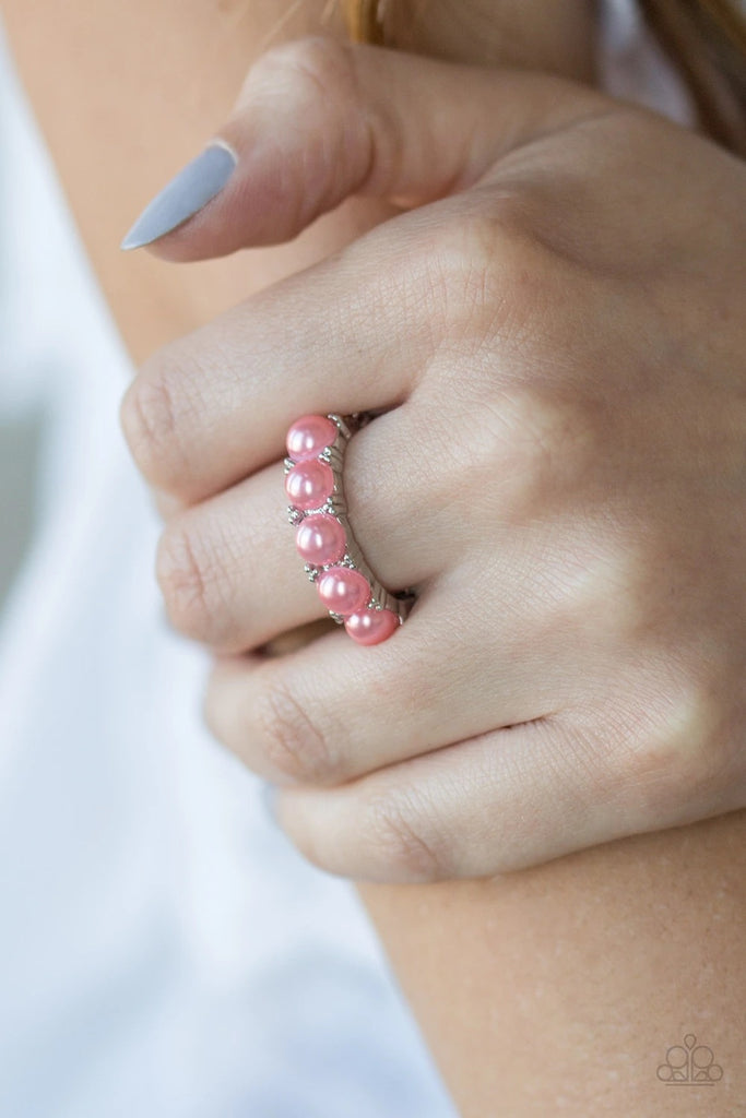 Bubbly coral pearls are encrusted along a dainty silver band for a whimsical look. Features a dainty stretchy band for a flexible fit.  Sold as one individual ring.