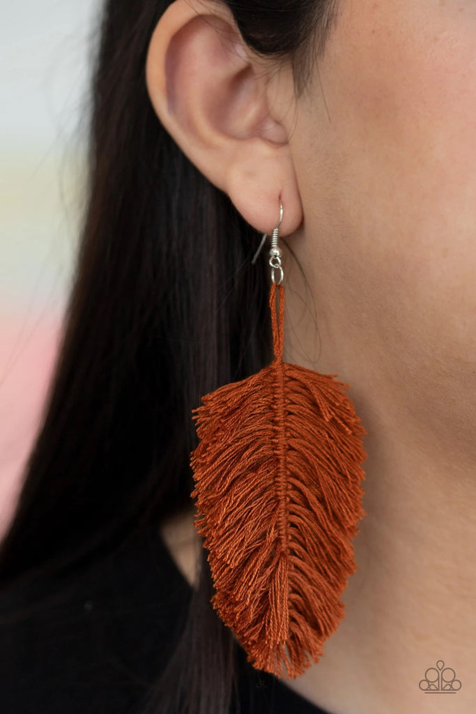 Featuring an earthy brown hue reminiscent of terracotta, a loop of thread gives way to a leafy brown fringe, creating a statement-making texture. Earring attaches to a standard fishhook fitting. Sold as one pair of earrings.