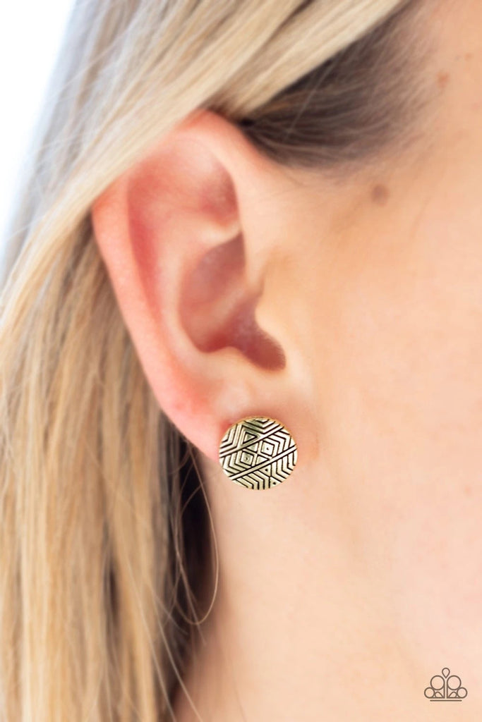 Stamped in tribal inspired textures, a round brass frame is brushed in an antiqued shimmer for a seasonal look. Earring attaches to a standard post fitting.  Sold as one pair of post earrings.