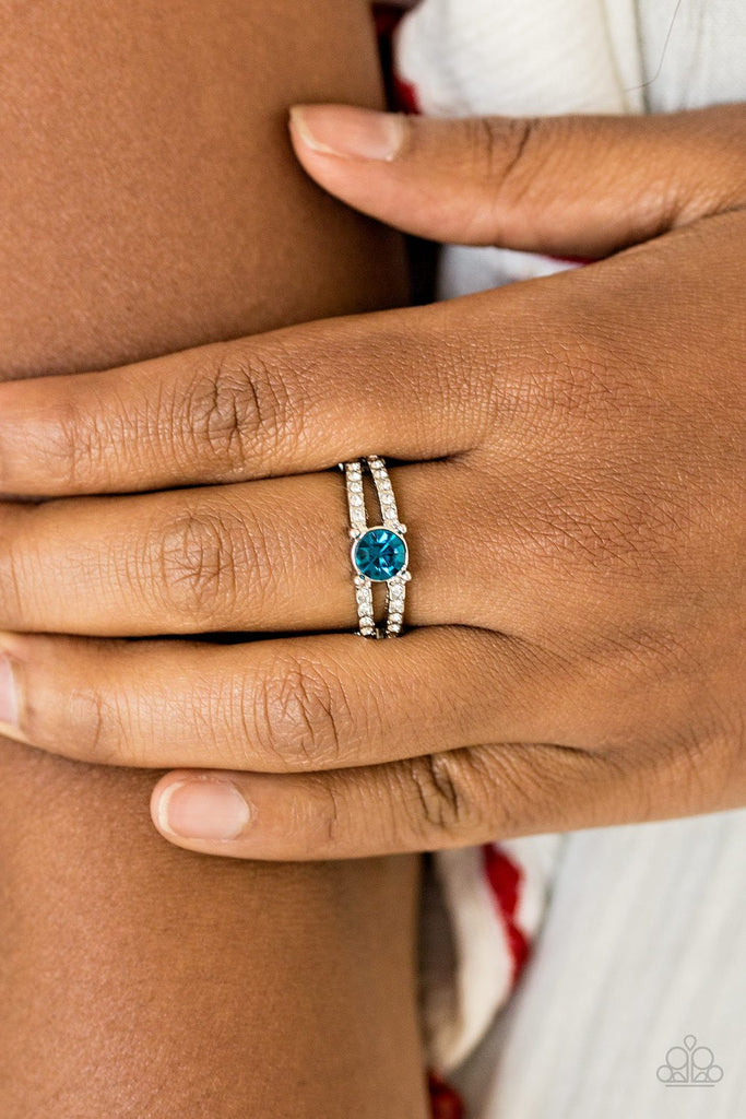 A glittery blue rhinestone sits atop two shimmery silver bands encrusted in glassy white rhinestones for a glamorous look. Features a dainty stretchy band for a flexible fit.  Sold as one individual ring.