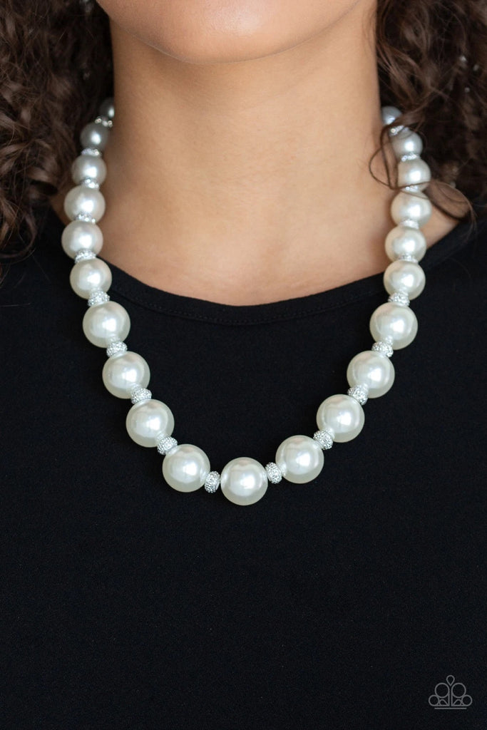 Infused with dainty silvery rhinestone encrusted beads, a refined collection of over sized white pearls are threaded along an invisible wire below the collar for a timeless dazzle. Features an adjustable clasp closure.  Sold as one individual necklace. Includes one pair of matching earrings.
