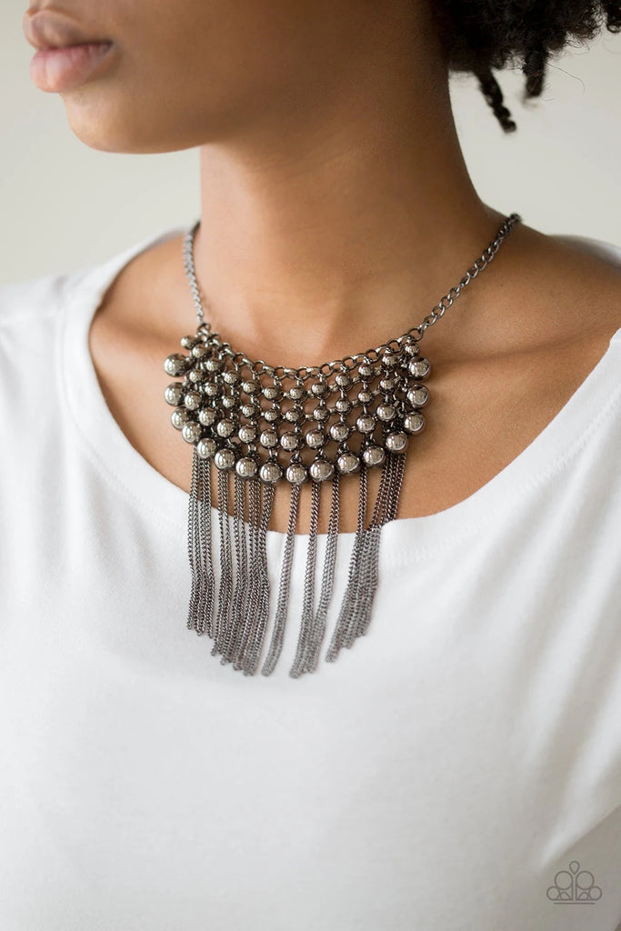 Gradually increasing in size, glistening gunmetal beads swing from a net of interlocking gunmetal links. Shimmery gunmetal chains stream from the bottom of the beaded fringe for an edgy finish. Features an adjustable clasp closure.  Sold as one individual necklace. Includes one pair of matching earrings.