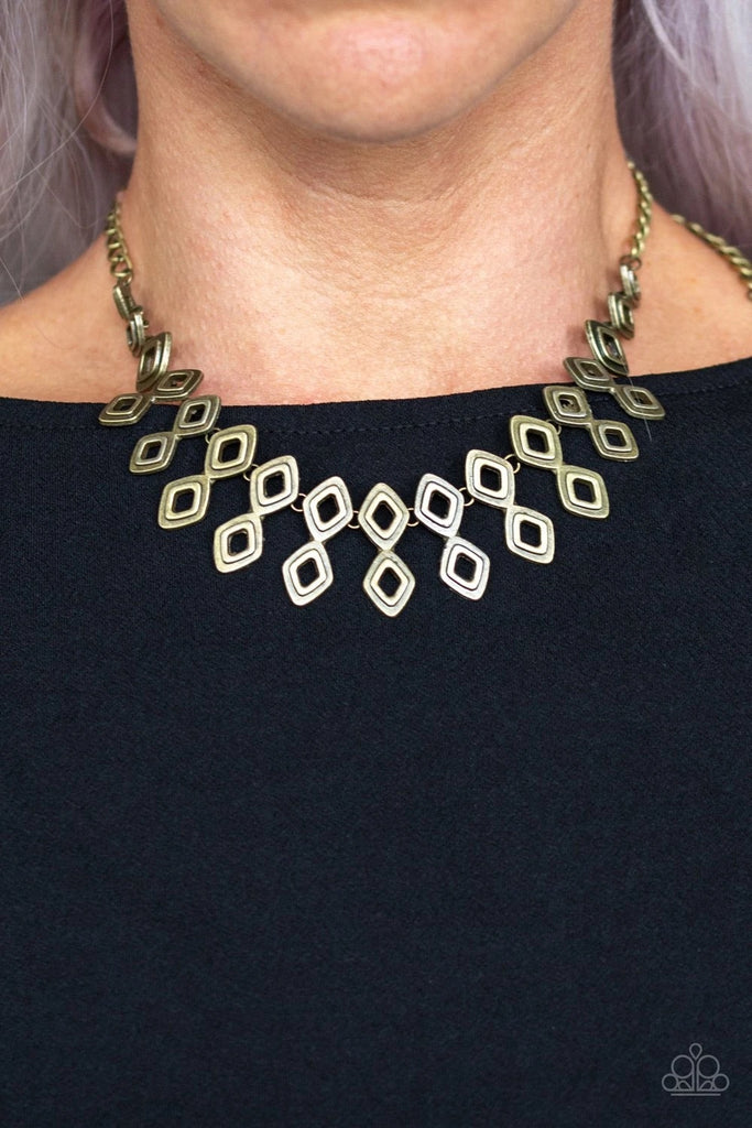 Brushed in an antiqued shimmer, glistening diamond-shaped brass frames link below the collar, coalescing into an edgy geometric fringe. Features an adjustable clasp closure.  Sold as one individual necklace. Includes one pair of matching earrings.