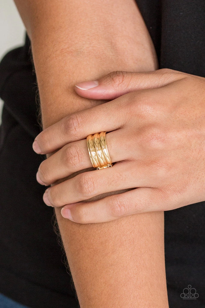 Brushed in a high-sheen finish, ribbed gold bands stack across the finger for an edgy industrial look. Features a stretchy band for a flexible fit.  Sold as one individual ring.