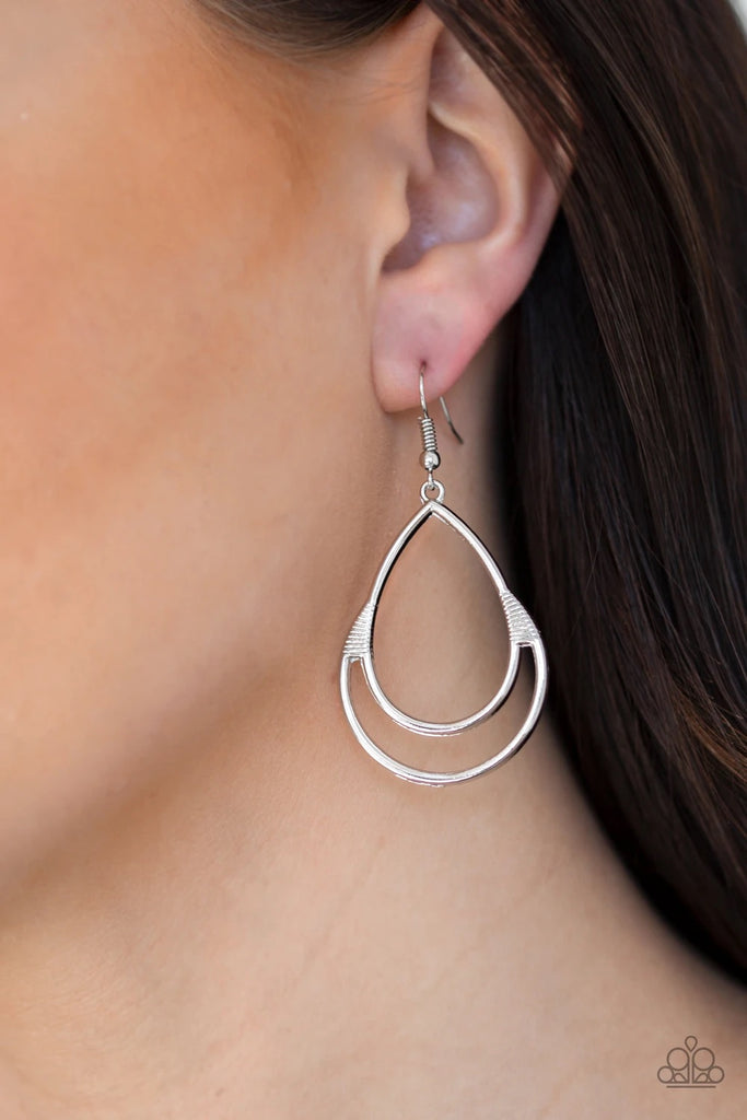An abstract silver teardrop frame swings from the ear for a casual look. Earring attaches to a standard fishhook fitting.  Sold as one pair of earrings.