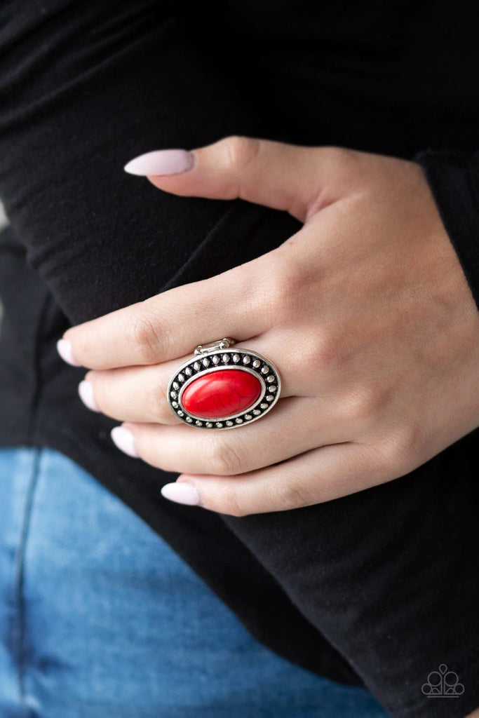 Chiseled into a smooth oval, a fiery red stone is pressed into a studded silver frame for a seasonal flair. Features a stretchy band for a flexible fit.  Sold as one individual ring.