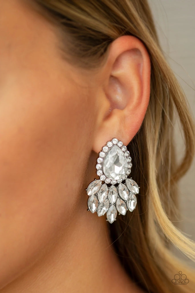 Glassy white marquise style rhinestones cascade from the bottom of a dramatically oversized white teardrop gem, coalescing into a regal frame. Earring attaches to a standard post fitting.  Sold as one pair of post earrings.