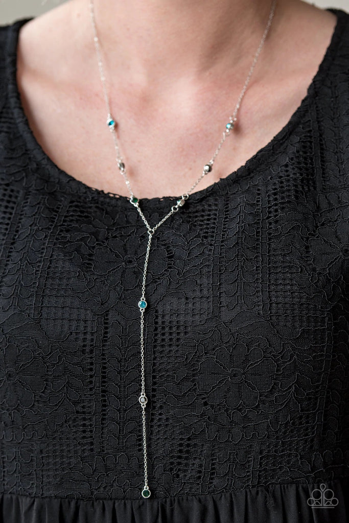 Pressed into sleek shiny silver frames, glittery blue, green, and hematite rhinestones trickle along a dainty silver chain. Matching rhinestones drip down an extended chain, creating an elegantly lengthened pendant. Features an adjustable clasp closure.  Sold as one individual necklace. Includes one pair of matching earrings.