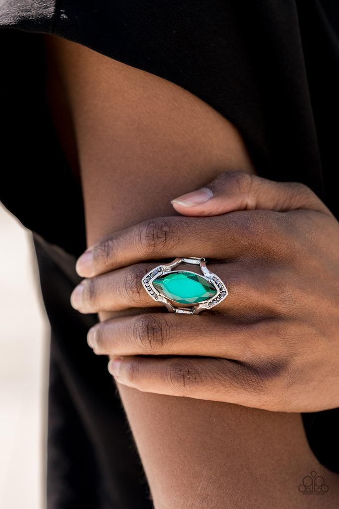 Smoky hematite rhinestones are encrusted across the top and bottom angles of an airy silver frame. Featuring a faceted finish, a boldly cut green gem is nestled between the arcing bars for an edgy fashion. Features a stretchy band for a flexible fit.  Sold as one individual ring.