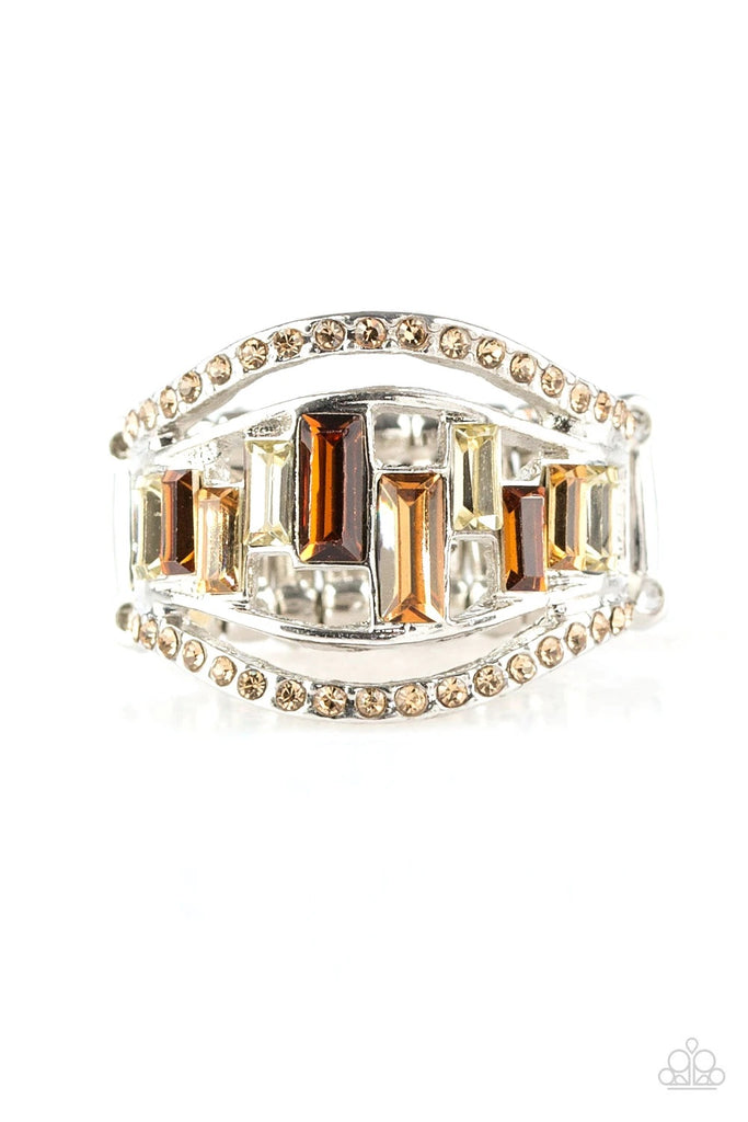 Topaz rhinestone encrusted bands flank a row of emerald cut glass beads in shades of brown and white for a regal look. Features a stretchy band for a flexible fit.  Sold as one individual ring.