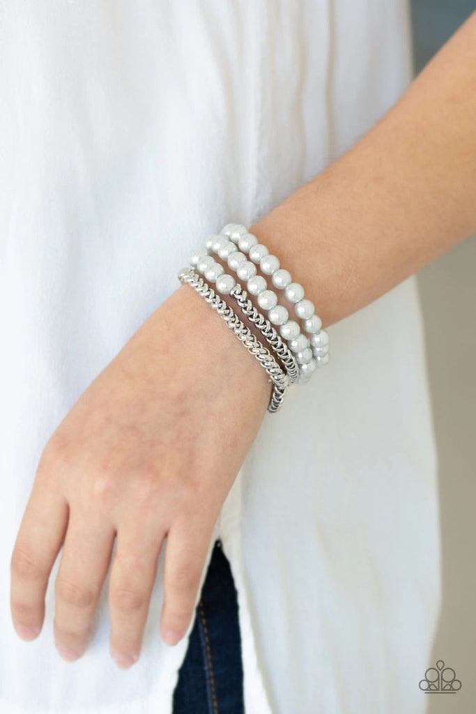 A collection of pearly silver beads and glistening silver chains are threaded along stretchy bands, creating a bold collision of industrial glamour.  Sold as one set of four bracelets.