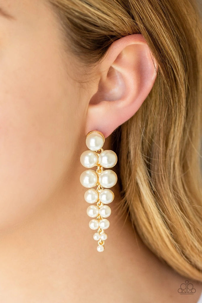 Gradually decreasing in size, pairs of classic white pearls drip from a solitaire pearl, coalescing into a dramatic triangular-shaped lure. Earring attaches to a standard post fitting.  Sold as one pair of post earrings.