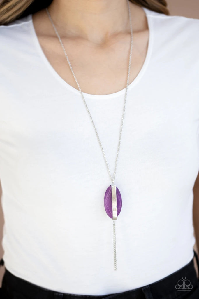 Threaded through a rod, an ethereal purple stone sits inside a rectangular silver fitting, giving way to a shimmery silver chain tassel for a tranquil finish. Features an adjustable clasp closure.  Sold as one individual necklace. Includes one pair of matching earrings.  