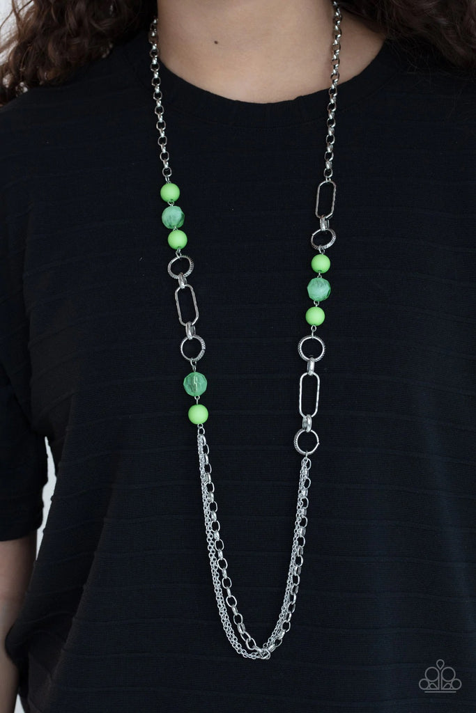 Apple green opaque round beads and transparent faceted beads playfully accent textured round and oval hoops midway down a large silver chain. A triple set of large and small linked chains creates a delightful finish. Features an adjustable clasp closure.  Sold as one individual necklace. Includes one pair of matching earrings.  