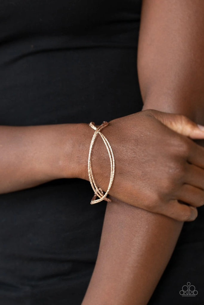 Featuring diamond-cut texture, dainty rose gold bars delicately crisscross over and around the wrist, coalescing into an airy cuff.  Sold as one individual bracelet.
