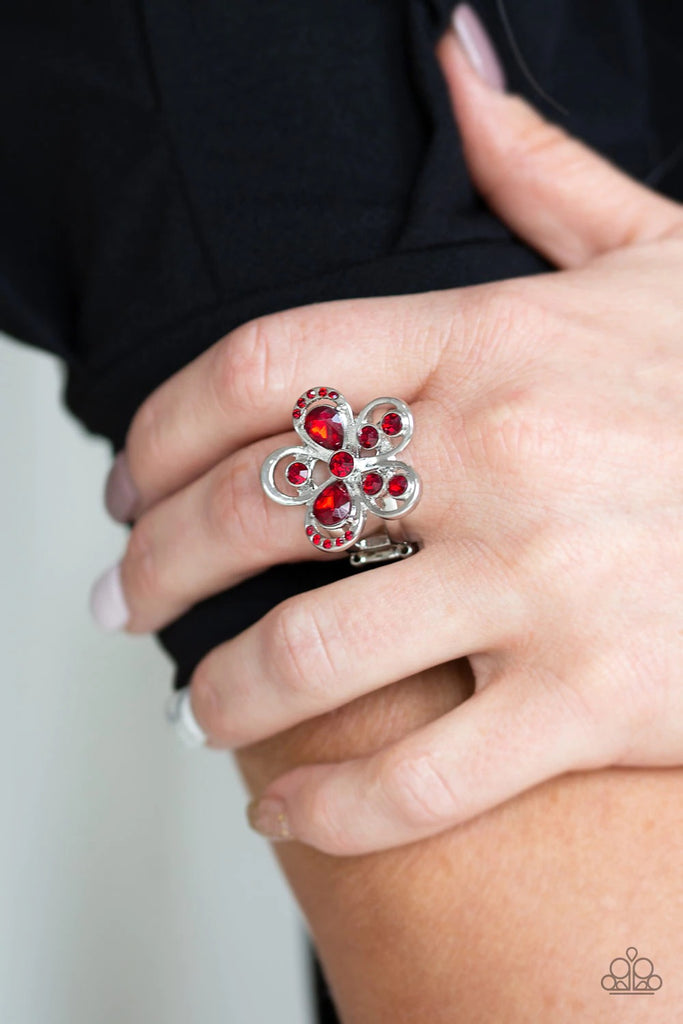 Varying in shape and size, fiery red rhinestones are sprinkled along airy silver petals, coalescing into a glittery flower atop the finger. Features a stretchy band for a flexible fit.  Sold as one individual ring.