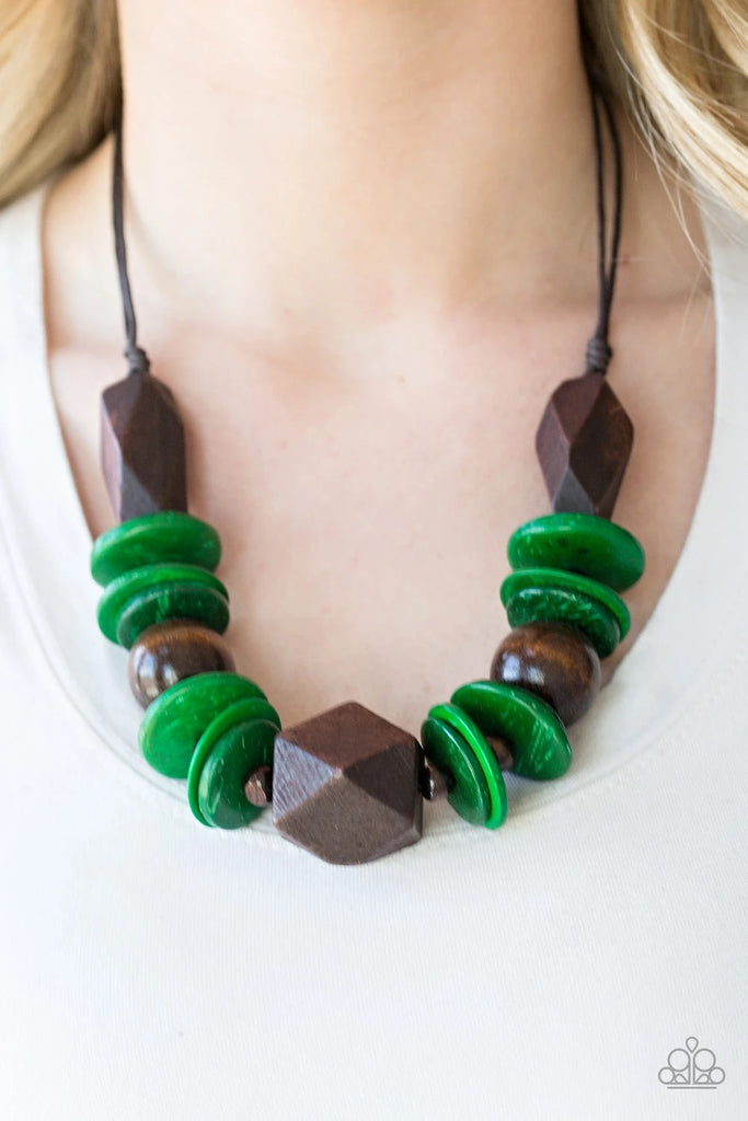 Featuring abstract geometric finishes, mismatched brown wooden beads and refreshing green accents are threaded along shiny brown cording. A dramatic geometric bead adorns the center, creating a bold summery look below the collar. Features a button loop closure.  Sold as one individual necklace. Includes one pair of matching earrings.