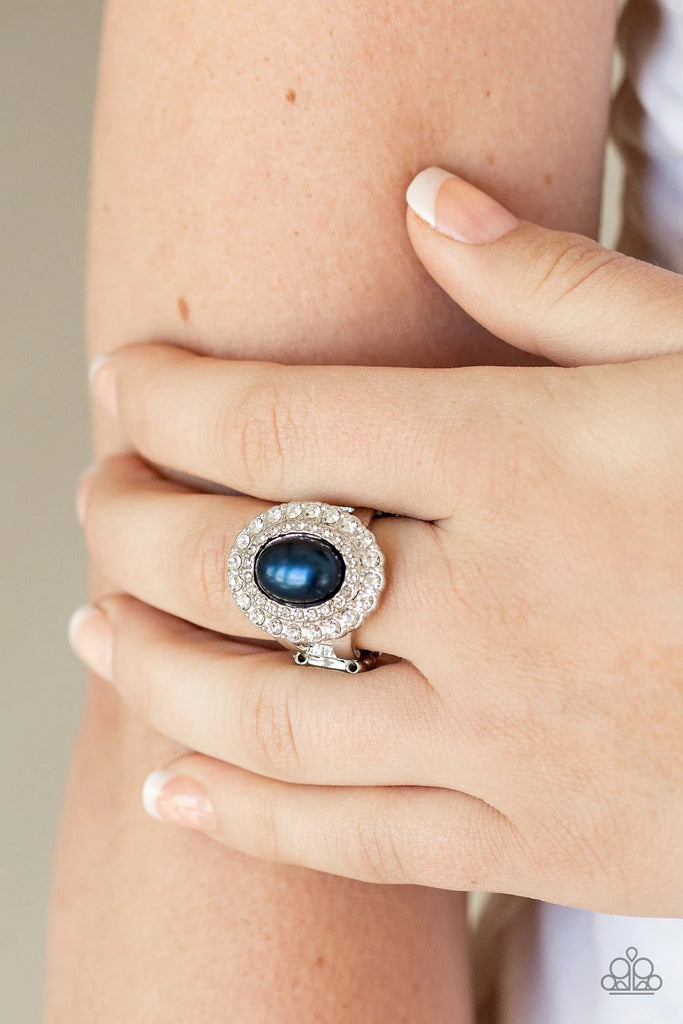 Two rings of glassy white rhinestones spin around a pearly blue center for a refined flair. Features a stretchy band for a flexible fit.  Sold as one individual ring.