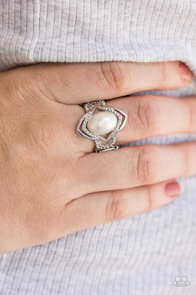 A pearly white bead is pressed into the center of an arcing silver frame for a refined look. Dainty white rhinestones are sprinkling along the inner silver frame, adding timeless shimmer to the classic piece.  Sold as one individual ring.