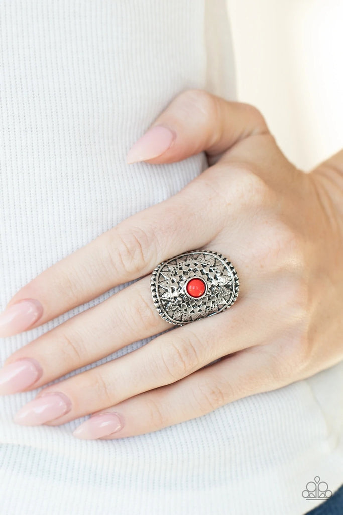An antiqued silver sunburst pattern blooms from a vivacious red beaded center, creating a radiant frame atop the finger. Features a stretchy band for a flexible fit.  Sold as one individual ring.