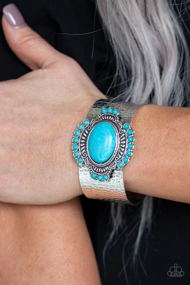 Radiating with refreshing turquoise stones and tribal inspired patterns, an ornate stone frame is pressed into the center of a hammered silver cuff for an artisan flair. Sold as one individual bracelet.