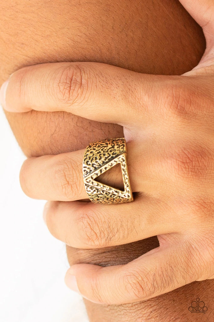 An airy triangular frame is pressed into the center of a hammered brass band for an edgy look. Features a stretchy band for a flexible fit.  Sold as one individual ring.