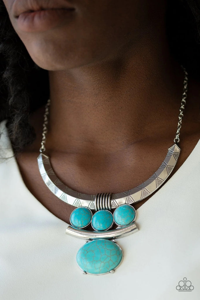 Oversized turquoise stone accents alternate with mismatched silver frames, coalescing into a dramatic tribal inspired pendant below the collar. Features an adjustable clasp closure.  Sold as one individual necklace. Includes one pair of matching earrings.