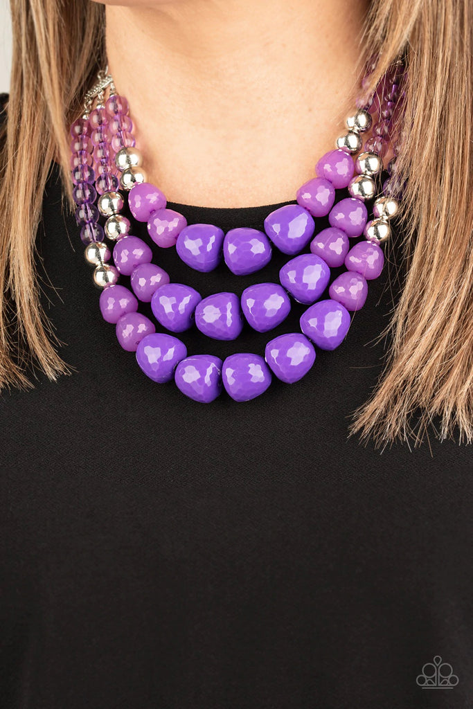 Varying in shape and opacity, a collection of round and asymmetrical purple beads are threaded along invisible wires below the collar. Shiny silver beads sprinkled along the strands, adding hints of shimmer to the fruity layers. Features an adjustable clasp closure.  Sold as one individual necklace. Includes one pair of matching earrings.