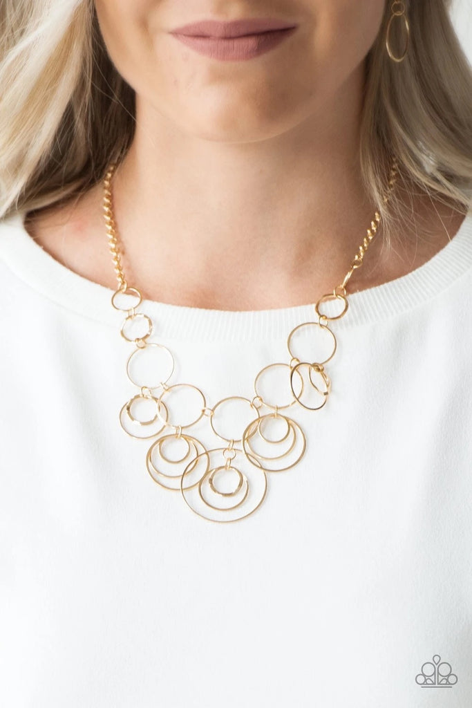 Featuring smooth and delicately hammered finishes, mismatched gold hoops connect below the collar for a bold industrial look. Features an adjustable clasp closure.  Sold as one individual necklace. Includes one pair of matching earrings