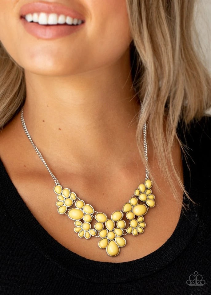 Featuring round, teardrop, and oval shapes, a shiny collection of dainty yellow beads delicately link into bubbly silver frames, creating a whimsical pop of color below the collar. Features an adjustable clasp closure.  Sold as one individual necklace. Includes one pair of matching earrings.