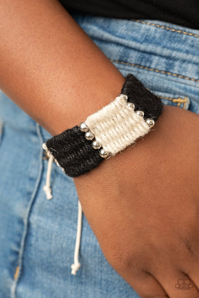 Infused with classic silver beads, white and black twine-like cording knots and weaves around the wrist for a colorful beach inspired look. Features an adjustable sliding knot closure.  Sold as one individual bracelet.