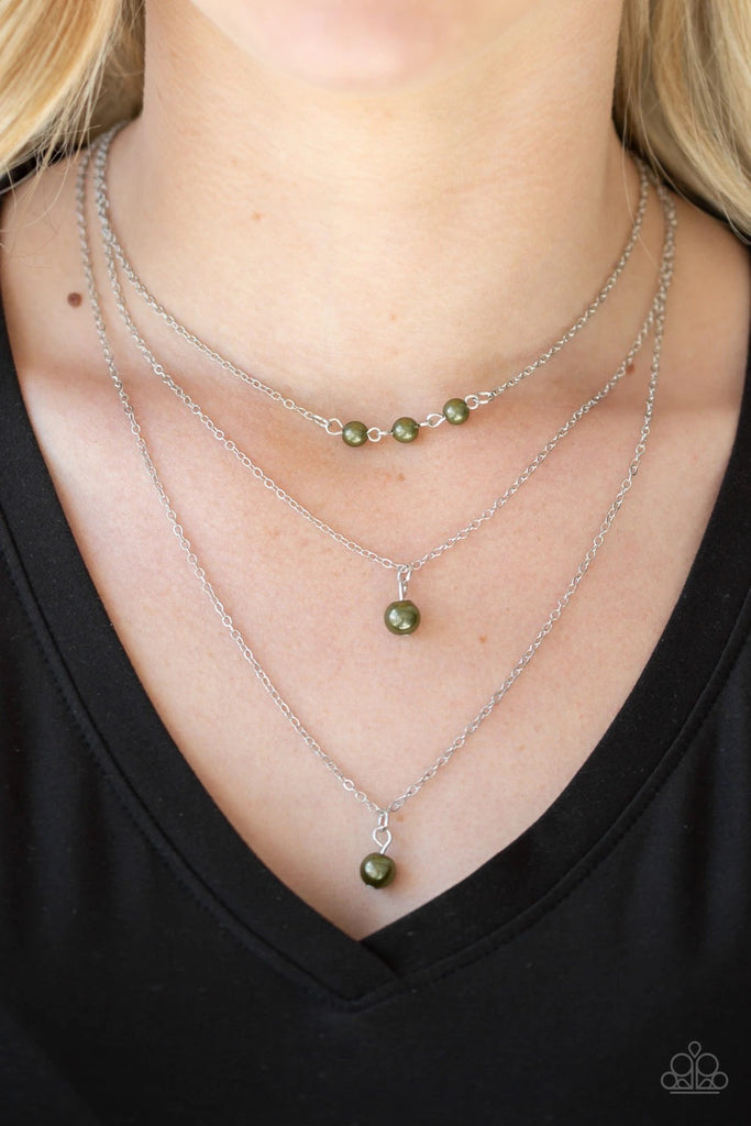 A trio of pearly green beads give way to layers of solitaire green pearl pendants below the collar for a refined flair. Features an adjustable clasp closure.  Sold as one individual necklace. Includes one pair of matching earrings.