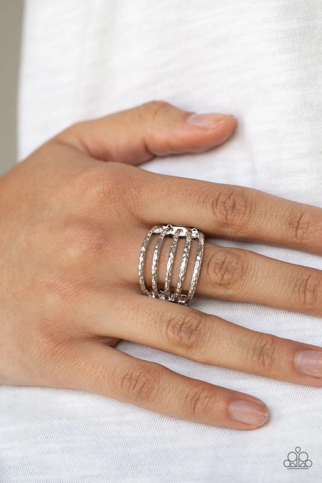 Delicately hammered in endless shimmer, glistening silver bands stack across the finger, creating an airy frame. Features a stretchy band for a flexible fit. Sold as one individual ring.