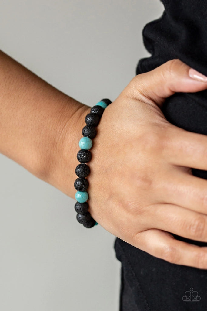 A collection of black lava rock and refreshing turquoise stone beads are threaded along a stretchy band around the wrist for a seasonal look.  Sold as one individual bracelet.