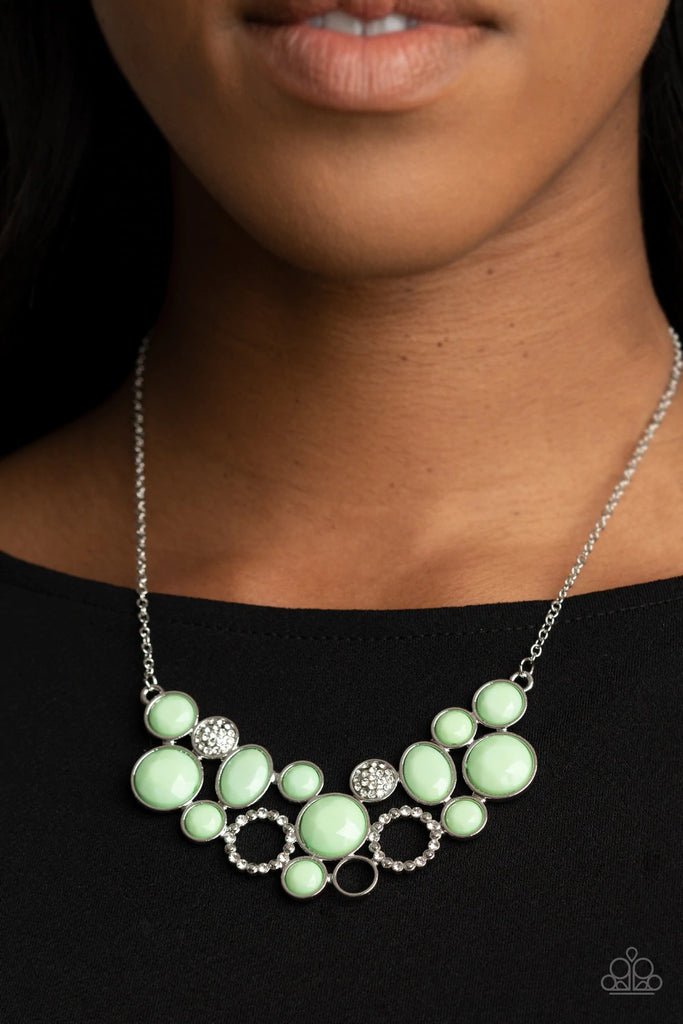 A mismatched collection of faceted minty green beaded frames and white rhinestone embellished accents delicately connect into a bubbly clustered pendant below the collar, creating a colorful statement piece. Features an adjustable clasp closure.  Sold as one individual necklace. Includes one pair of matching earrings.  