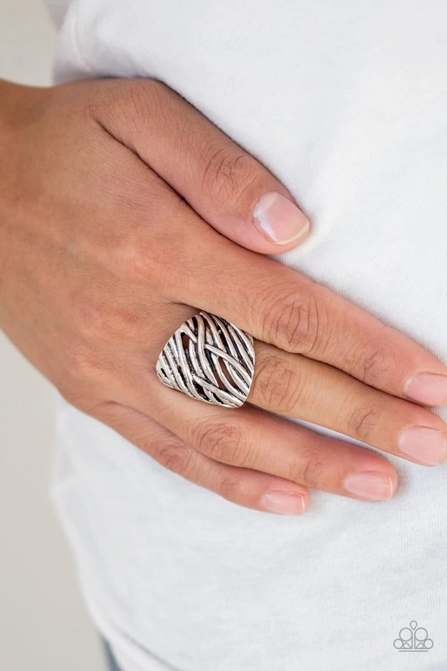Brushed in an antiqued shimmer, glistening silver bars delicately crisscross across the finger, coalescing into an edgy frame. Features a stretchy band for a flexible fit. Sold as one individual ring.