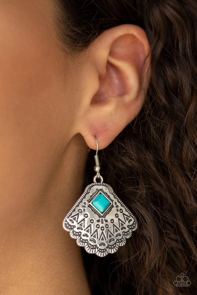 Stamped in tribal inspired patterns, a shimmery silver frame fans out from the bottom of a square turquoise stone for a seasonal flair. Earring attaches to a standard fishhook fitting.  Sold as one pair of earrings.