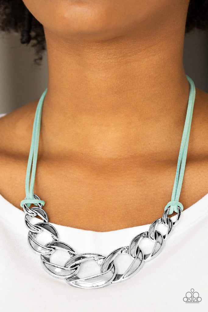 Strands of blue suede knot around interconnecting silver links, creating a bold pendant below the collar. Features an adjustable clasp closure.  Sold as one individual necklace. Includes one pair of matching earrings.  