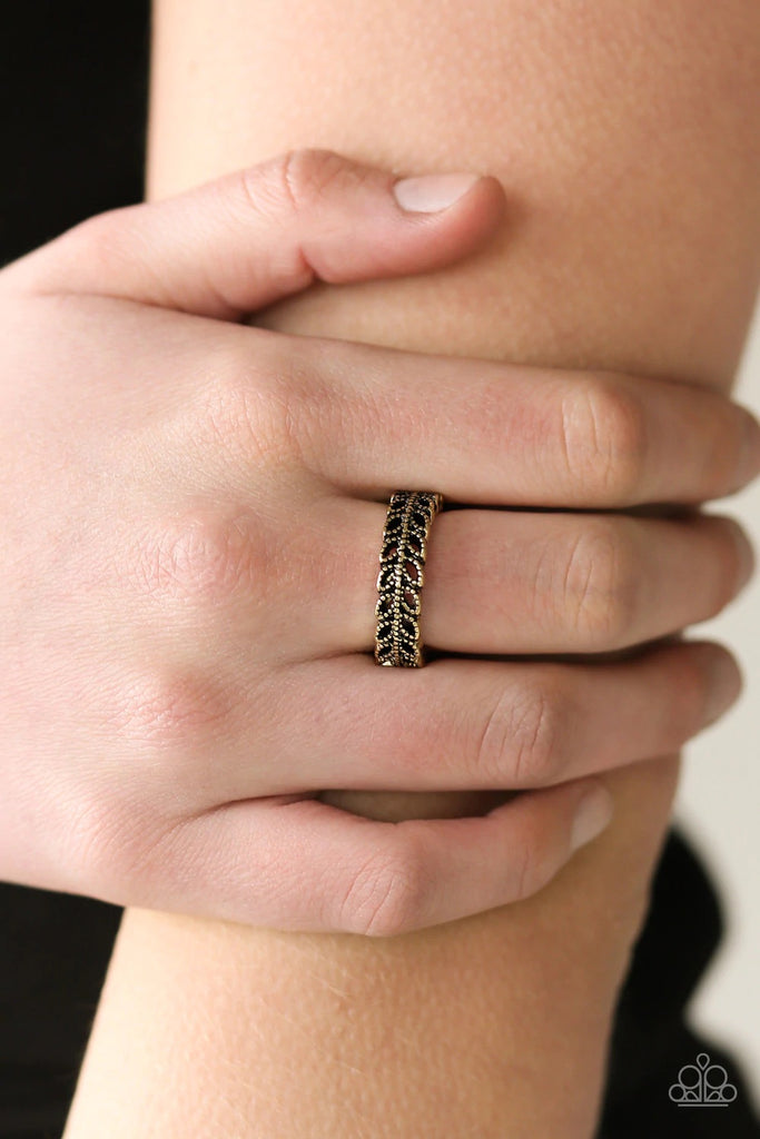 Dotted in studded textures, a leafy brass band curls across the finger for a seasonal look. Features a dainty stretchy band for a flexible fit.  Sold as one individual ring.