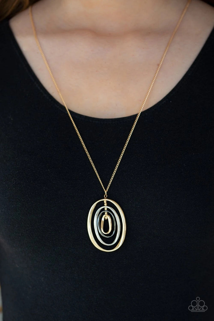 Threaded along a gold-beaded rod, mismatched gold, silver, and gunmetal ovals ripple into a dizzying pendant at the bottom of a lengthened gold chain. Features an adjustable clasp closure.  Sold as one individual necklace. Includes one pair of matching earrings.