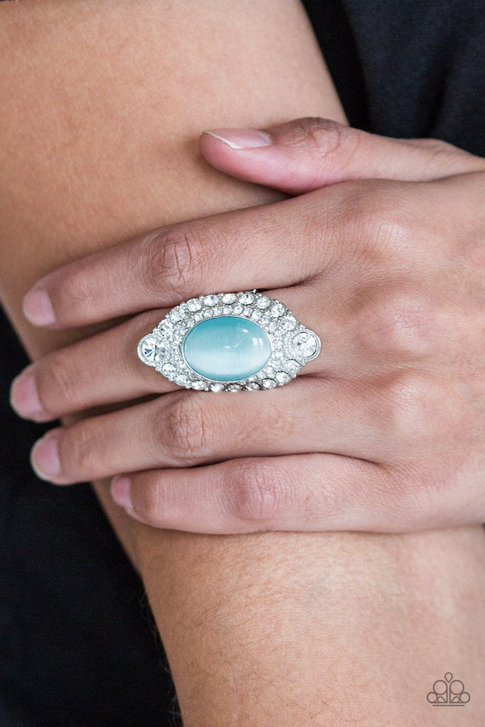 A glowing blue moonstone is pressed into a dramatic silver band radiating with glassy white rhinestones for a glamorous flair. Features a stretchy band for a flexible fit.  Sold as one individual ring.