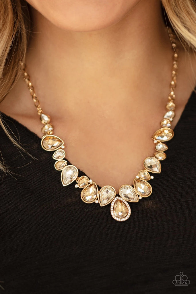 A sassy combination of golden and white teardrop gems delicately link into a stunning piece below the collar. Dainty white rhinestones are scattered through the piece for unexpected hints of shimmer. Features an adjustable clasp closure.  Sold as one individual necklace. Includes one pair of matching earrings.