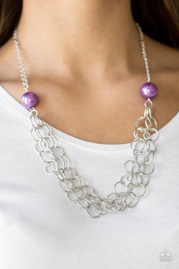 Two oversized purple pearls give way to dramatic silver chains, creating bold layers below the collar for a sassy look. Features an adjustable clasp closure.  Sold as one individual necklace. Includes one pair of matching earrings.  