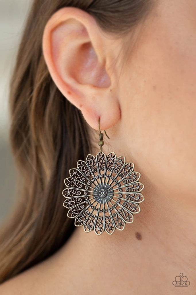 Radiating with ornate filigree details, brass petals flare out from a dizzying center, coalescing into a whimsical frame. Earring attaches to a standard fishhook fitting.  Sold as one pair of earrings.