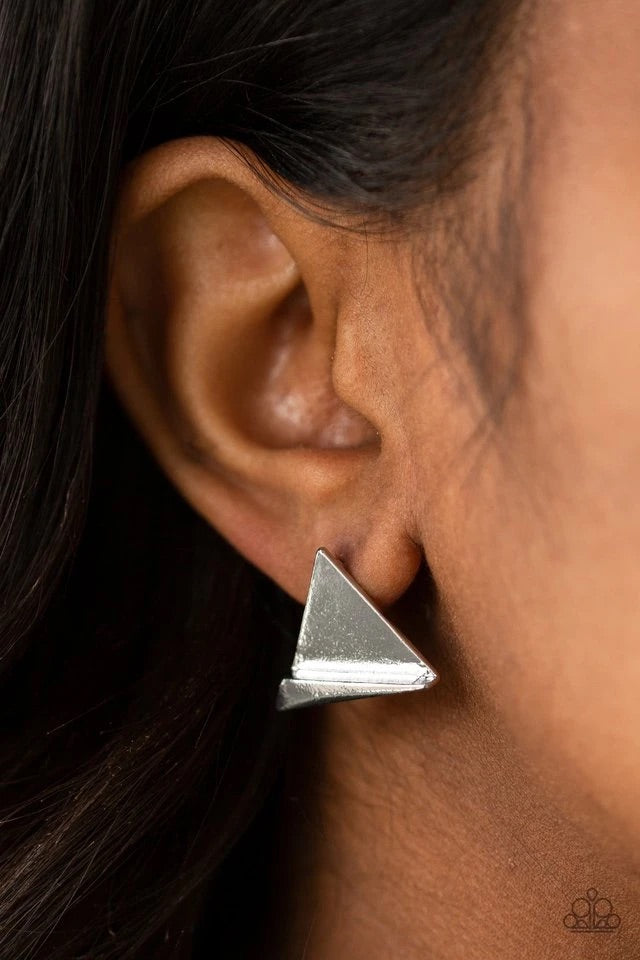 An angular frame is pressed into the bottom of a flat silver triangle, coalescing into an edgy frame. Earring attaches to a standard post fitting.  Sold as one pair of post earrings.