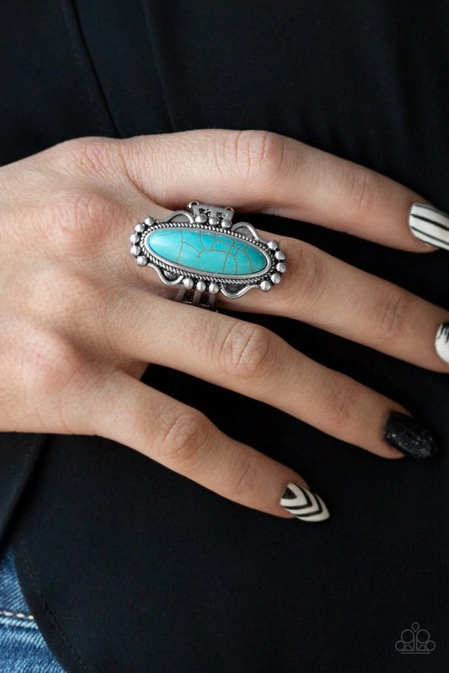 An oblong turquoise stone is pressed into the center of an ornate silver frame for a seasonal look. Features a stretchy band for a flexible fit. Sold as one individual ring.