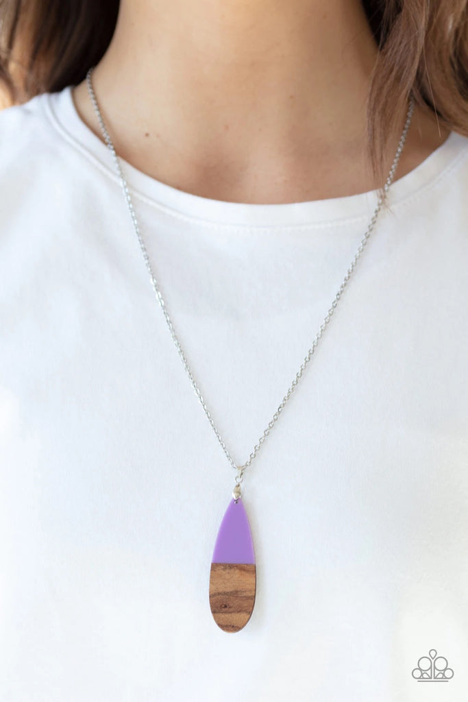 Dipped in a purple finish, a wooden teardrop pendant swings from the bottom of a lengthened silver chain for a colorful earthy look. Features an adjustable clasp closure.  Sold as one individual necklace. Includes one pair of matching earrings.