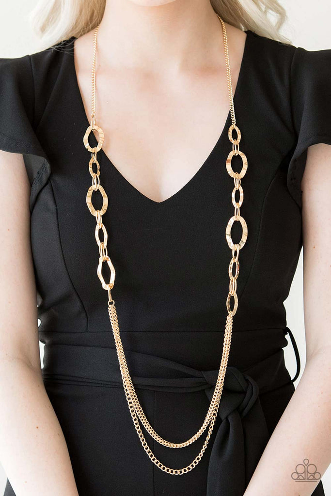 Hammered gold rings give way to rows of mismatched gold chains, creating edgy layers down the chest. Features an adjustable clasp closure.  Sold as one individual necklace. Includes one pair of matching earrings.